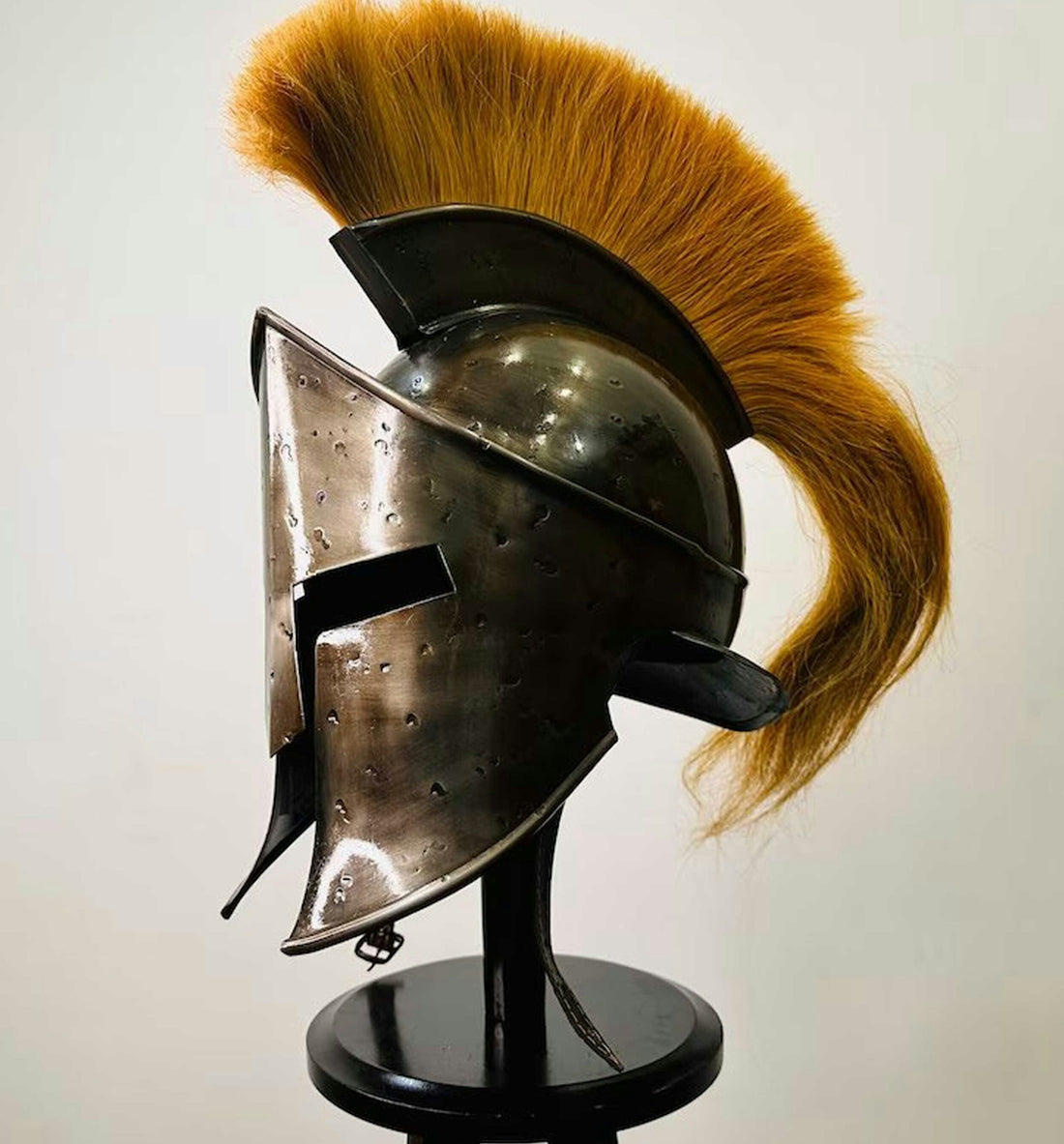 a helmet with a red tail on a stand