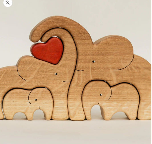 A Wooden Statue Of The Elephant Family At Home